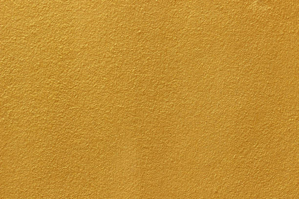 istock Gold paint on cement wall texture or backgrond 1291694387