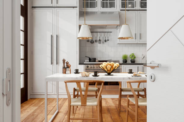 nowoczesne wnętrze kuchni z drewnianymi krzesłami, lampami wiszącymi, marmurowym stołem i otwartymi drzwiami do kuchni. - color image photography nobody food zdjęcia i obrazy z banku zdjęć
