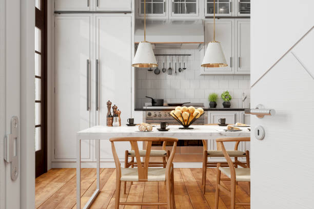 interior de cozinha moderno com cadeiras de madeira, luzes pendentes, mesa de mármore e porta aberta para a cozinha. - sala de jantar - fotografias e filmes do acervo