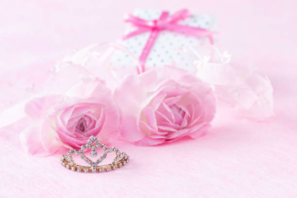 istock Pink Ranunculus and present and tiara 1291711678
