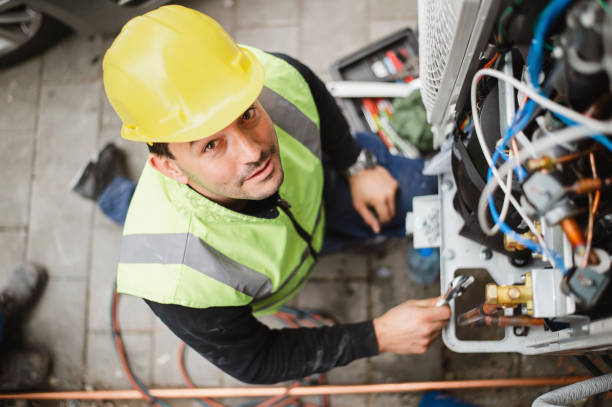 Air conditioner technician services outdoor AC unit and the Gas Generator stock photo