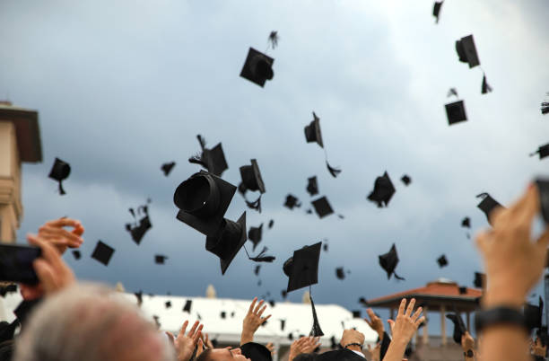 Graduation Caps. Graduation Caps Thrown in the Air at Koc University. alumni stock pictures, royalty-free photos & images