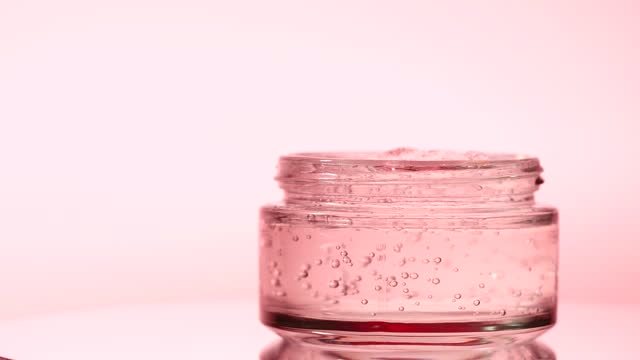 Close-up of pink rose flower hyaluronic acid transparent fluid gel