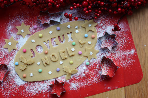 istock Joyeux Noel.Cookie dough letters on wooden table 1291726334
