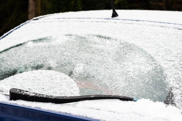 istock Car windows and wipers covered with snow in winter 1291726388