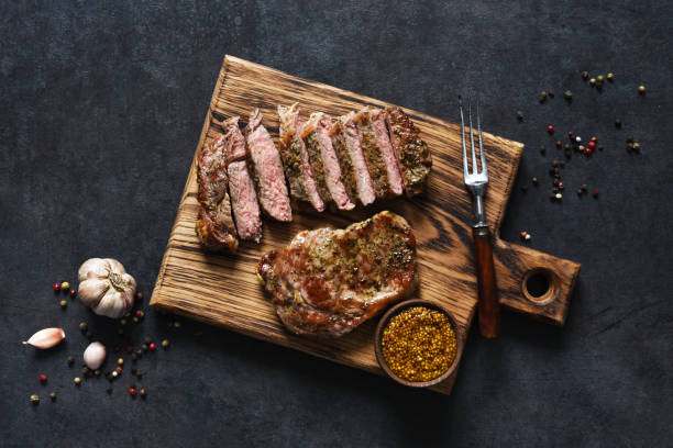 istock Grilled beef steak with herbs and spices. Top view with space to copy text 1291728845