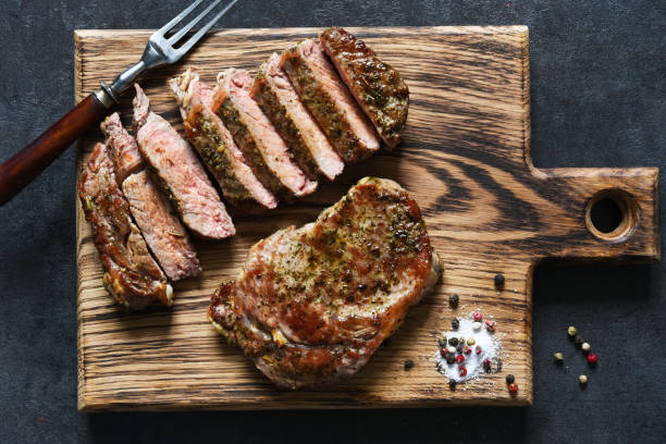 grilled beef steak with herbs and spices. top view with space to copy text - top sirloin imagens e fotografias de stock