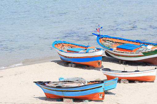 Sandy beach in Hammamet with lots of traditional fishing boats, Tunisia