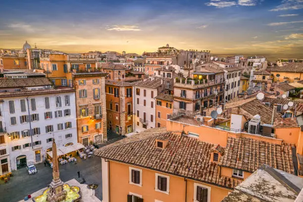Photo of An idyllic sunset over the rooftops of the heart of Rome seen from a terrace in the Pantheon district