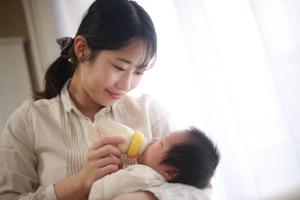 istock Mother feeding her baby 1291730212