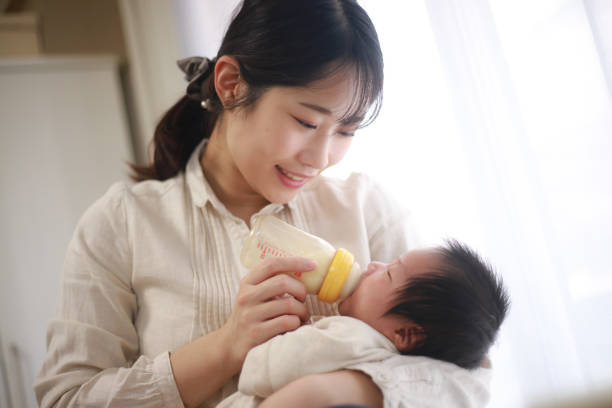 istock Mother feeding her baby 1291730219