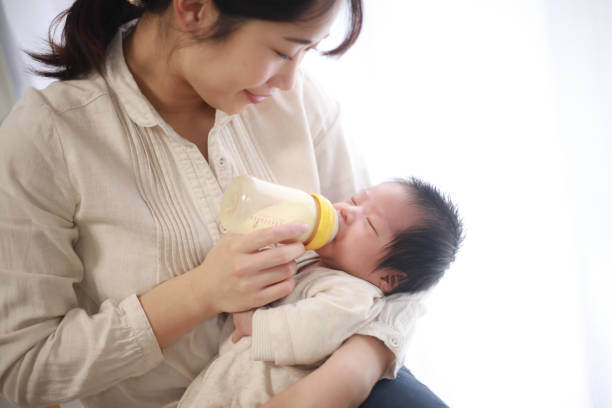 istock Mother feeding her baby 1291730233