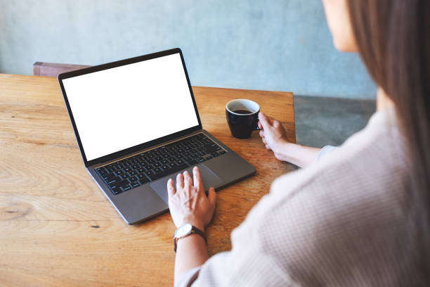 istock a woman touching on laptop computer touchpad with blank white desktop screen while drinking coffee 1291730411