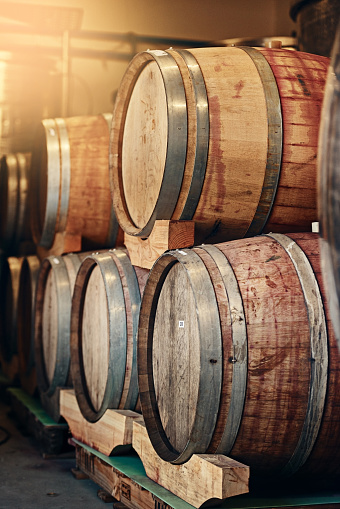 Cropped shot of barrels of wine stacked on each other in a wine distillery