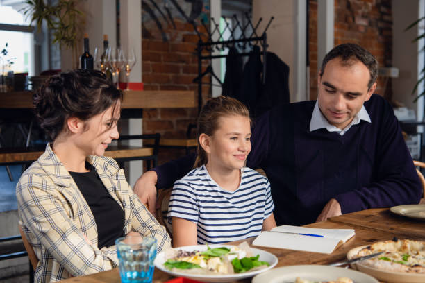 istock Young parents helping their daughter with her homework 1291731543