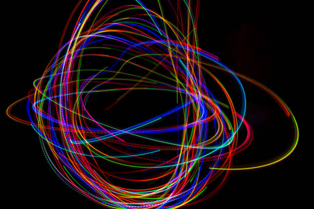 istock Abstract multicolored lines drawn by light on a black background 1291731976