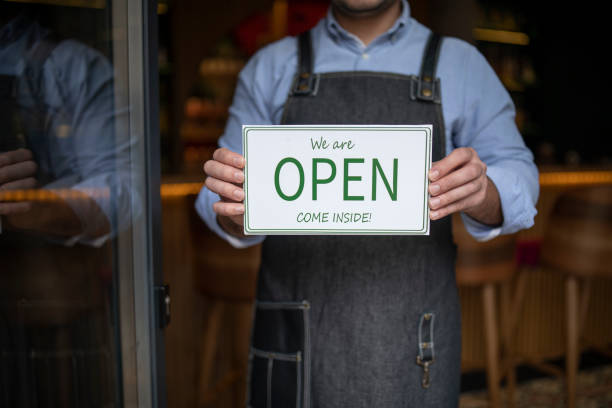 istock Owner with apron opening his cafeteria. 1291732731