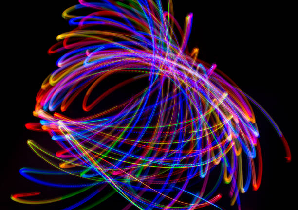 istock Abstract multicolored lines drawn by light on a black background 1291732775