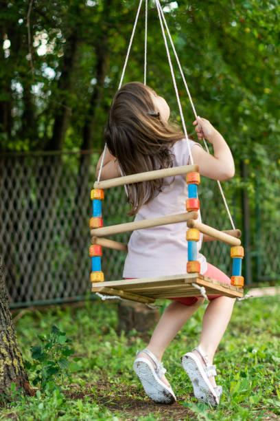 istock Girl on a swing in the yard 1291732810