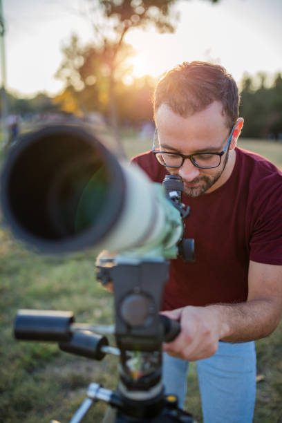 istock Amateur astronomer looking at the sky with a telescope. 1291733085