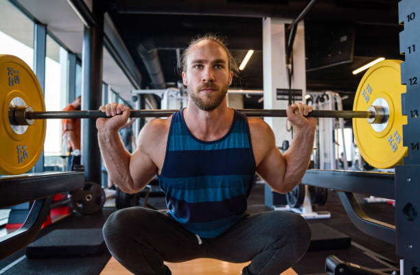 istock Young muscular man during workout in the gym 1291735119