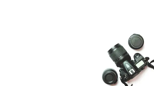 Photo of top view of a digital camera, flash, accessories on a white background. Photo equipment.