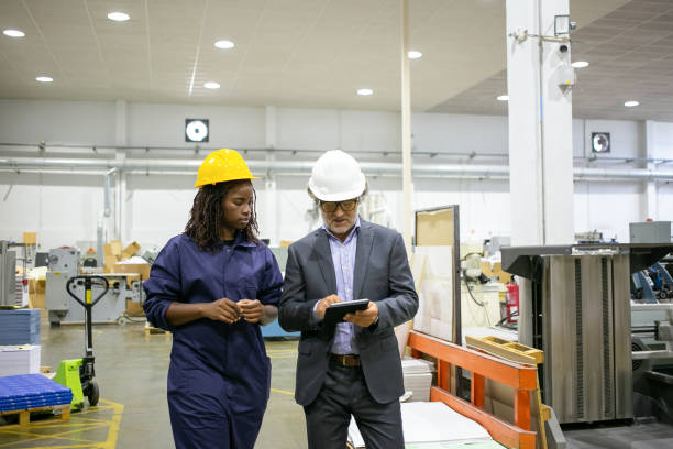 istock Caucasian manager discussing factory work with African worker 1291735979