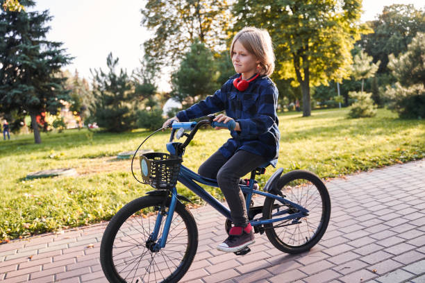 istock Child riding bicycle on a street 1291740025