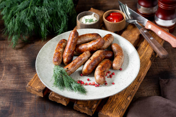 Bavarian sausages. Pork sausages in a plate on a brown wooden table. Delicious Nuremberg sausages Bavarian sausages. Pork sausages in a plate on a brown wooden table. Delicious Nuremberg sausages turkish sausage stock pictures, royalty-free photos & images