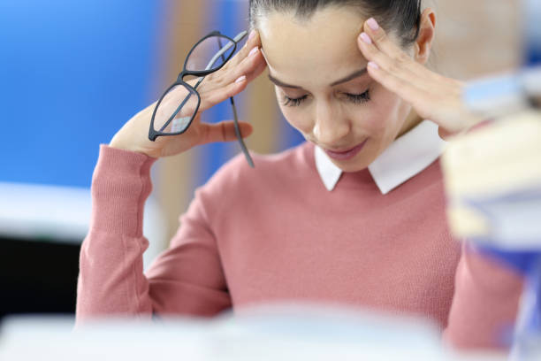 istock Tired woman at the work table. irregular working hours 1291742616