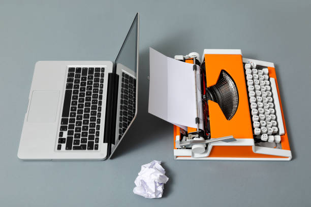 istock Digital and analog – Laptop and 70s Typewriter 1291743604