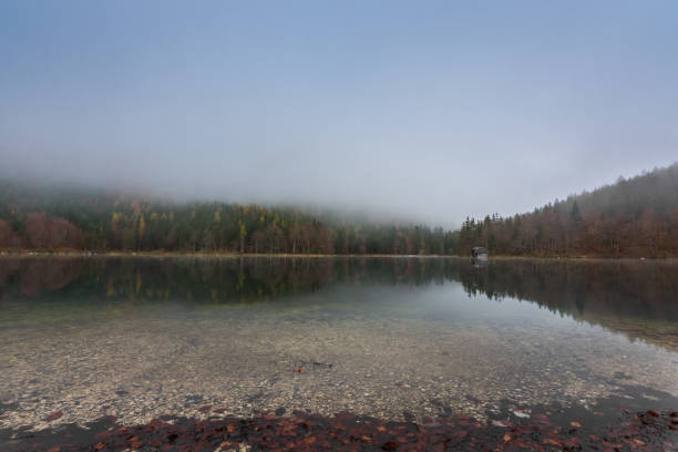 istock dense fog in autumn on a clear mountain lake 1291746165