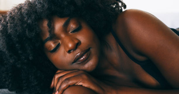 Shot of a young woman relaxing in bed at home