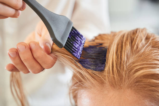 istock Hairdresser using a brush 1291747633