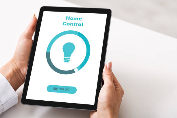 istock Unrecognizable Woman Using App On Digital Tablet For Smart Home Control, Collage 1291747646