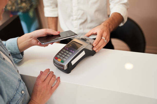 istock Woman paying with card contactless 1291751194