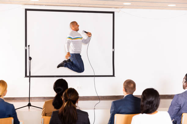 istock Expressive hispanic business coach speaking to audience and jumping 1291753552