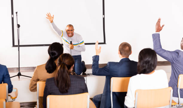 istock Excited Hispanic preacher giving motivational speech from stage 1291753559