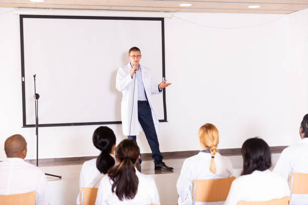 istock Male coach giving speech at conference hall 1291753561