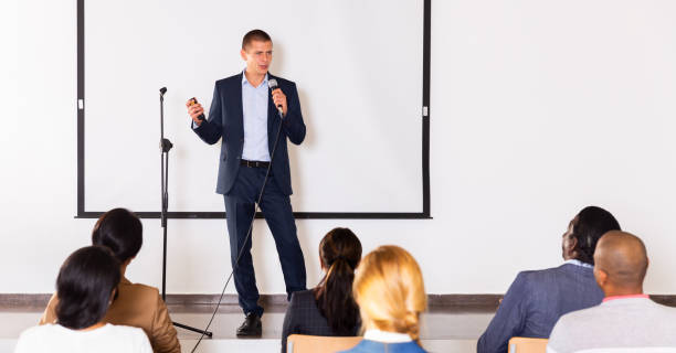 istock Male coach giving speech at conference hall 1291753718