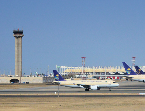 Jeddah, Saudi Arabia: King Abdulaziz International Airport (KAIA) - Control tower and Hajj Terminal, an open tent-like tensile structure built for Muslim pilgrims going to Mecca - parked Saudi Arabian Airlines aircraft - Jeddah International Airport - Mecca Region (Tihamah region of the Hejaz)