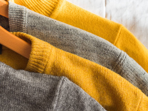 istock Yellow illuminated color and gray winter sweaters 1291756486