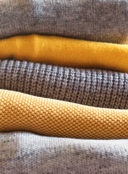 istock Yellow illuminated color and gray winter sweaters 1291756490