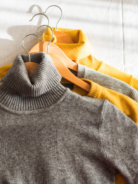 istock Yellow illuminated color and gray winter sweaters 1291756491