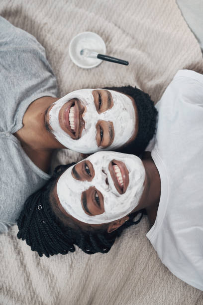 Romance isn't based on gender roles Shot of a young couple getting homemade facials together at home gender stereotypes photos stock pictures, royalty-free photos & images