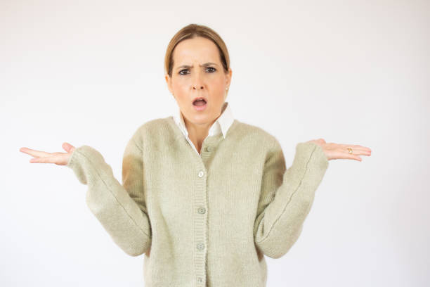 istock Young woman standing over white isolated background clueless and confused expression with arms and hands raised. Doubt concept. 1291759822