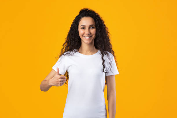 istock Smiling Lady Gesturing Thumbs Up Smiling To Camera, Studio Shot 1291760223