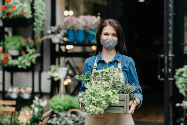 istock Plant care, gardener work, flower studio and new normal during covid-19 quarantine 1291760746