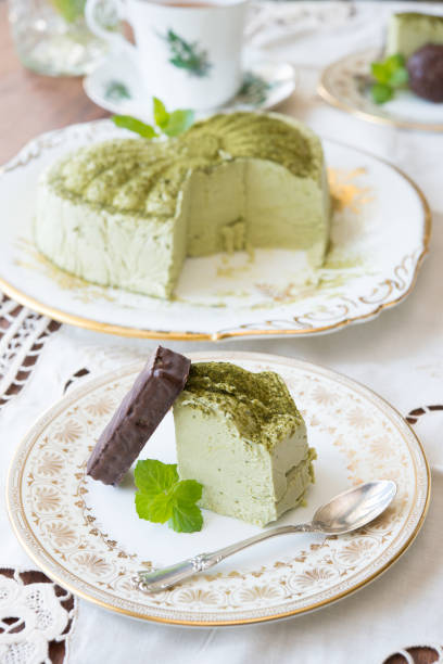 istock Matcha cheese cake slice and sterling siver spoon on antique plate 1291760932