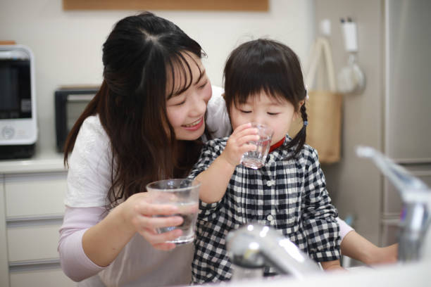 istock Parents and children drinking tap water 1291761304